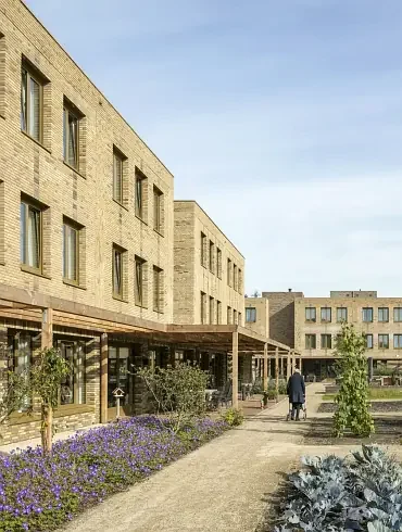 Person walking through a care community garden